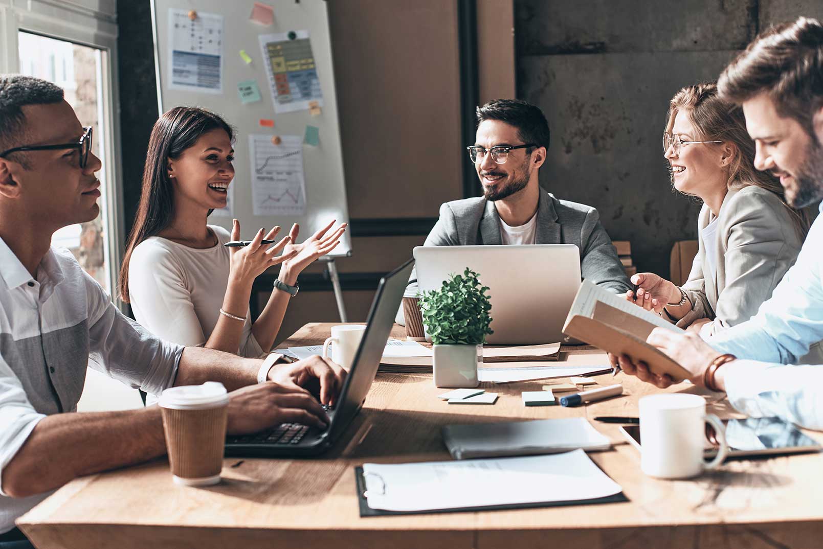 A happy group of business executives discussing complex business challenges