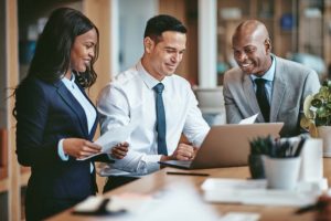 Three business executives review a written proposal