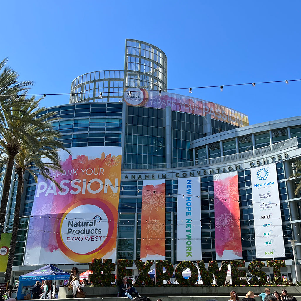 Exterior photo of the Anaheim Convention Center with banners advertising the Natural Products Expo West