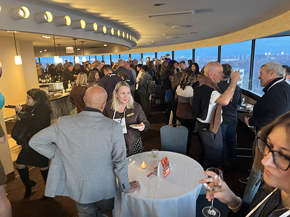 Room of people having conversations over cocktails