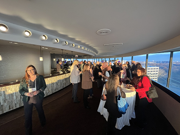 Room of people having conversations over cocktails