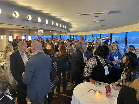 Room of people having conversations over cocktails