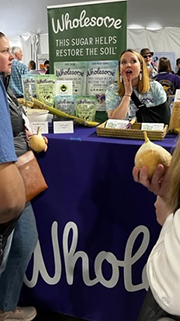 Wholesome Sugar’s booth featuring the tagline “this sugar helps restore the soil”