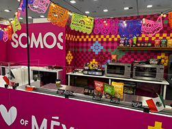 Somos’s Magenta themed booth featuring paper bunting.