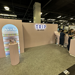 Expo West Tradeshow booth - mostly empty booth with one rack of samples and one sampling station 20 ft apart