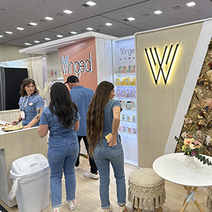 Expo West Tradeshow booth - team members wearing all denim serve snacks