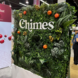 Expo West Tradeshow booth - sign for Chimes with plants growing out of it