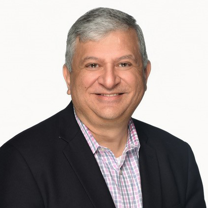 Yogesh Chavda head shot in a suit