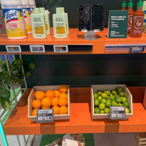 Digital shelf labels on an orange shelf with groceries on the shelf