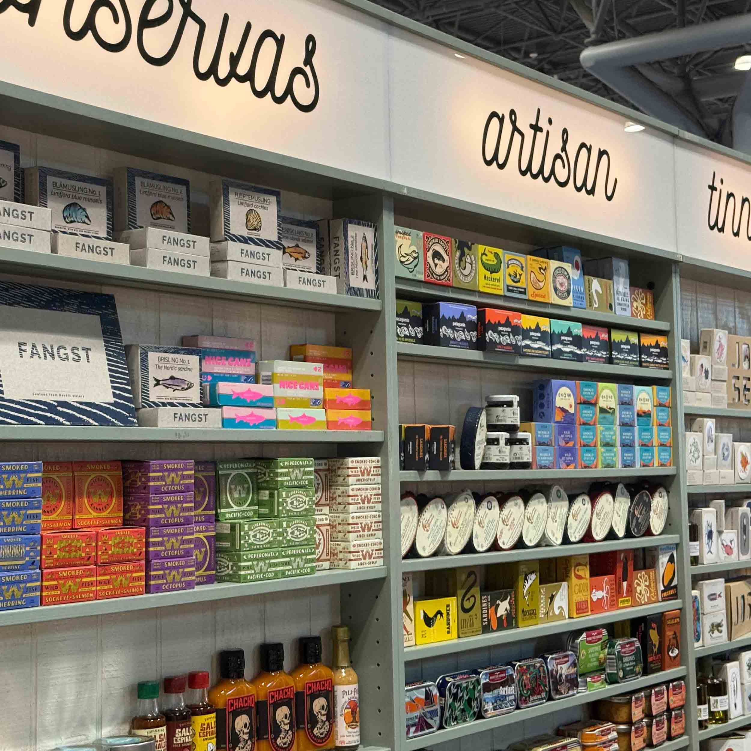 lines of tinned fish on shelves at the Fancy Food tradeshow