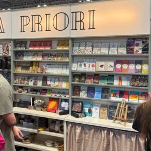 lines of chocolate and tinned fish shelves with colorful packaging at the Fancy Food tradeshow