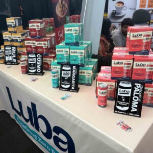 brightly colored boxes and cans of non-alcoholic cocktails on a white table