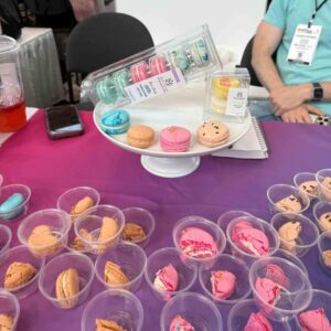 Brightly colored macarons on a pink/purple tablecloth