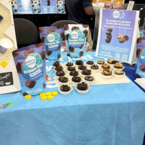 cups of brownie bites on a blue table cloth with blue bags