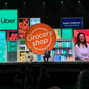 brightly colored background in front of a stage with two speakers