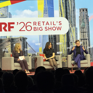 Three-person panel on NRF stage with PwC sponsorship visible, two women and one man discussing retail trends, colorful NYC graphics behind them.