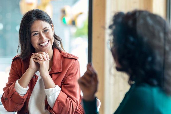 Peer Group Side Meeting Two female business professionals have a one-on-one meeting to discuss topics on detail